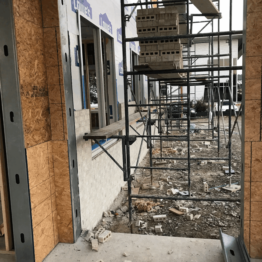 Construction site with scaffolding and building materials in progress.