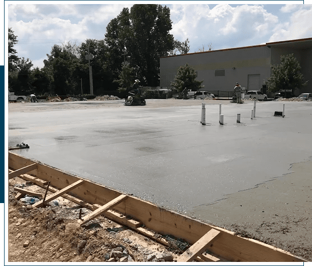 Freshly poured and smoothed concrete slab at a construction site.