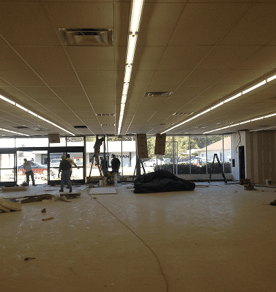 An empty, partially dismantled commercial space under renovation.
